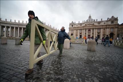 عمال يقومون بالأعمال التحضيرية في ساحة القديس بطرس في الفاتيكان أمس (أ ف ب) 